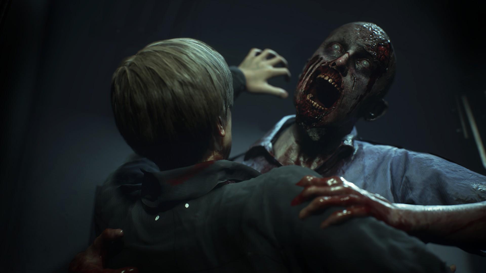 بهترین بازی های ترسناک - Resident Evil 2 remake screenshot of Leon Kennedy being attacked by a zombie who&#039;s trying bite him
