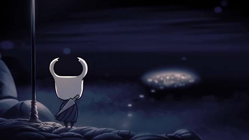 A screenshot of the Knight looking over the main city of Hollow Knight, یکی از بهترین بازی های Metroidvania.