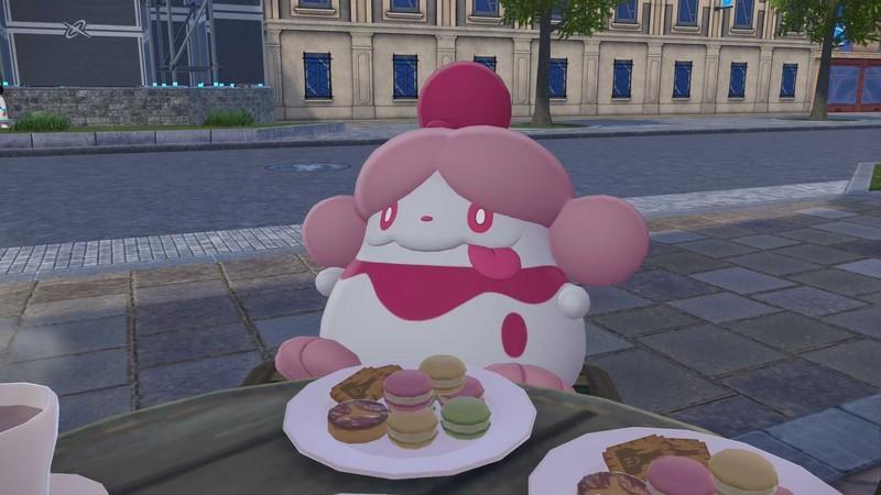 یک اسکرین شات از Slurpuff در حال خوردن شیرینی در یک کافه در تکامل پوکمون Pokemon Legends: Z-A.