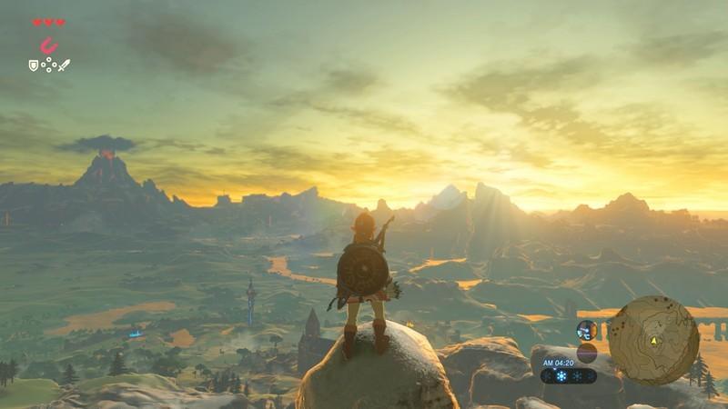بهترین بازی های Zelda: اسکرین شات The Legend of Breath of the Wild لینک رو در حال ایستادن روی یک قله بلند با منظره هایرول نشون میده