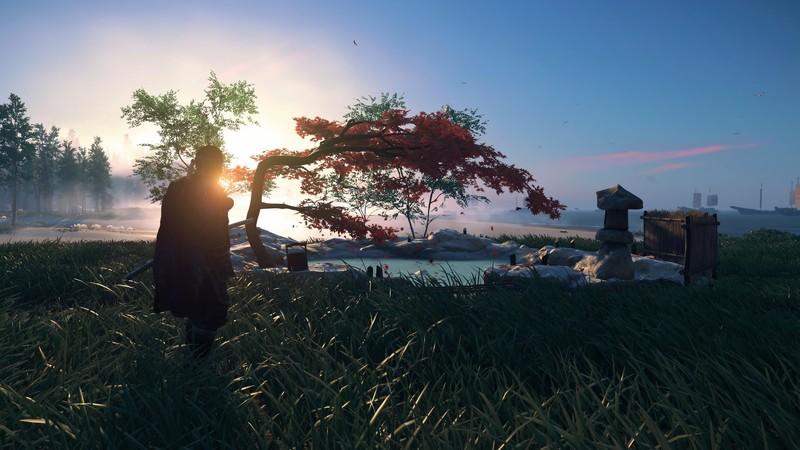 جین در زره Ghost در کنار چشمه آب گرم ساحلی هنگام طلوع آفتاب در Ghost of Tsushima، زیباترین بازی PS Plus